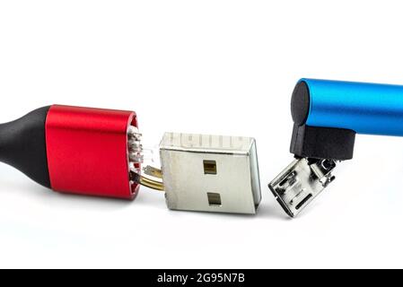 Macro shot of the red and blue damaged end of the USB 2.0 A-Type and Micro-B cable, isolated on a white background. Stock Photo