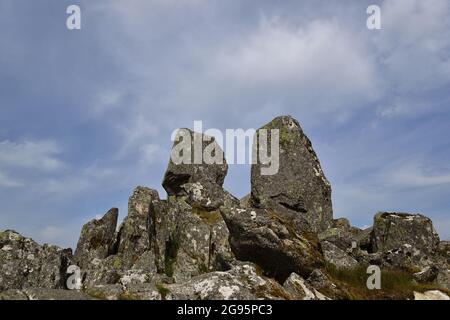 View of Adam and Eve stones on the summit of Mt Tryfan, set against blue cloudy sky Stock Photo