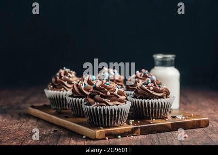 Chocolate cupcakes on a wooden board Stock Photo