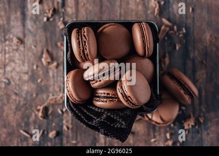 Chocolate macarons on wooden table Stock Photo