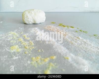 A piece of dough and four types of different flour on the table Stock Photo