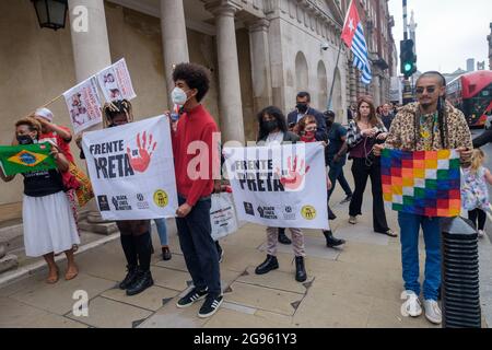 London, UK. 24th July 2012. Brazilians and supporters stop on Whitehall in their protestmarch against President Bolsonaro, currently under legal investigation for his mishandling of the pandemic. They demand food and vaccines for all, respect for indigenous rights and land, an end to police violence and the killing of black people, calling for an end to his anti-women, anti-worker, anti-gay government and its attack on science, education and culture. Peter Marshall/Alamy Live News Stock Photo