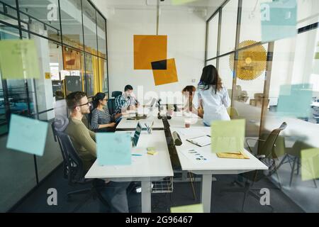 Hard-working young people working at modern office Stock Photo
