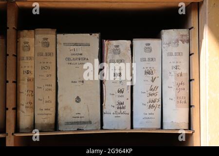 Ancient Italian law books from the 1800s in an old bookshelf Stock Photo