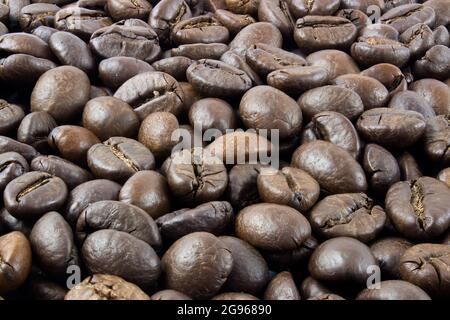 Roasted coffee beans, coffee beans text background in full focus Stock Photo