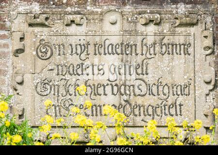 Text stone with old-Dutch language in the brick wall of the Southern lock. Schardam, North-Holland, the Netherlands Stock Photo