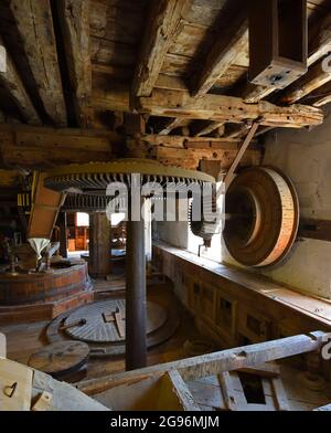 Water Mill stones and gears inside a floor mill Stock Photo
