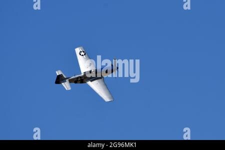 North American P-51D Mustang Aircraft 'Miss Helen' flying with blue sky background. Stock Photo