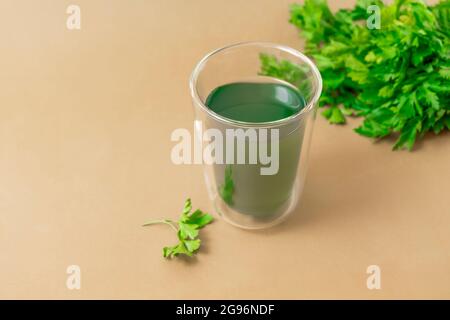 Cup of chlorophyll water on light beige background with copy space Stock Photo