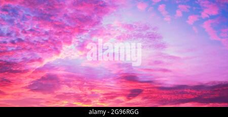 Dramatic purple sky with fluffy clouds Stock Photo