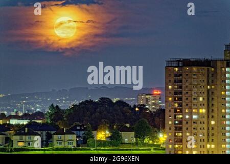 Glasgow, Scotland, UK, 24th  July, 2021. Full  July  Moon  known as the Buck Moon over the south east of the city and the cathkin braes hills saw increasing cloud signalling an end to the stunning weather over the city.  Credit: Gerard Ferry/Alamy Live News Stock Photo