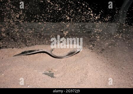 Cocoa splash with a spoon, studio shot Stock Photo