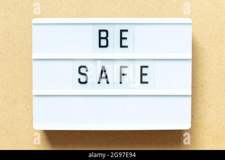 Lightbox with word be safe on wood background Stock Photo