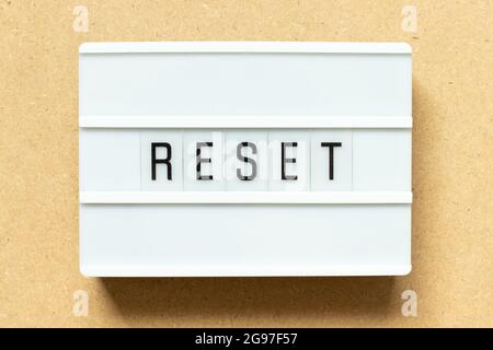 Lightbox with word reset on wood background Stock Photo