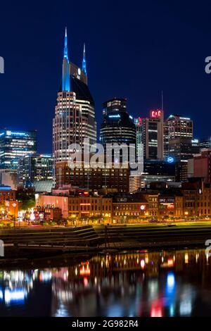 AT&T Building (Batman Building) in Downtown Nashville illuminated at night. View from Cumberland Park, Nashville, Tennessee, USA. Stock Photo