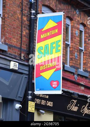 A street banner in Manchester, Greater Manchester, England, says: 'Maintain safe distance' during the Covid-19 pandemic Stock Photo
