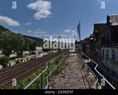 Beautiful view of the historic town wall of Oberwesel, Rhineland-Palatinate, Germany on Rhine riverbank with half-timbered houses, waving flags. Stock Photo