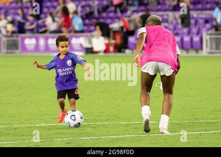 Orlando, United States. 25th July, 2021. Tziarra King (23 OL Reign) plays with Cassius (son of Sydney Leroux) after the National Women's Soccer League game between Orlando Pride and OL Reign at Exploria Stadium in Orlando, Florida. NO COMMERCIAL USAGE. Credit: SPP Sport Press Photo. /Alamy Live News Stock Photo