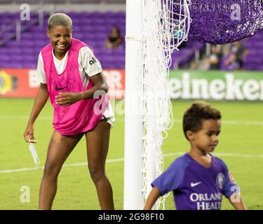 Orlando, United States. 25th July, 2021. Tziarra King (23 OL Reign) laughs after playing some soccer with the son of Sydney Leroux (2 Orlando Pride), Cassius, after the National Women's Soccer League game between Orlando Pride and OL Reign at Exploria Stadium in Orlando, Florida. NO COMMERCIAL USAGE. Credit: SPP Sport Press Photo. /Alamy Live News Stock Photo