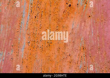 Old Red Rusty Plaster Wall With Worn Surface Vertical Empty Grunge Background. Empty Painted Vintage Grunge Wallpaper Stock Photo