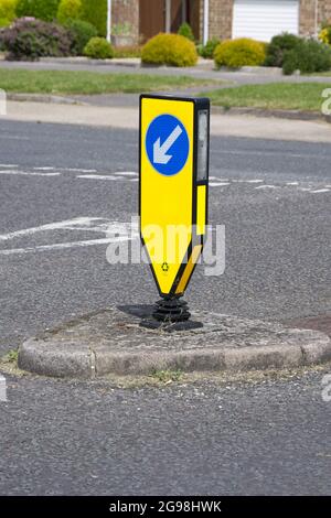 yellow reboundable illuminated bollard with keep left signage, at T junction UK Stock Photo