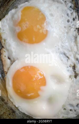 Scrambled eggs from two eggs in a frying pan Stock Photo