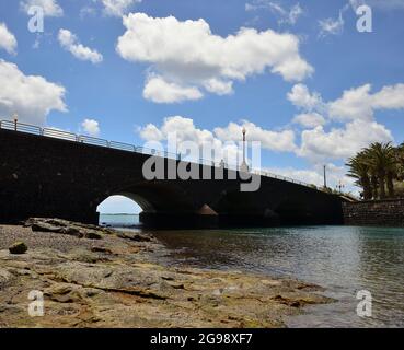 Stone bridge view from the shore, littoral of Arrecife, Lanzarote Island, Spain Stock Photo