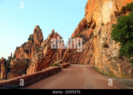 very scenic road called D81 Route in French Corsica which crosses very breathtaking red rocks Stock Photo