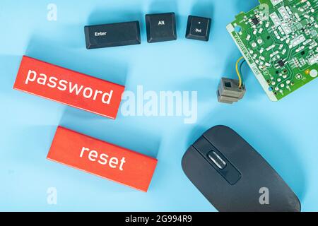 Business concept. Layout of mouse, small motherboard, keyboard button, wooden block and text password reset Stock Photo
