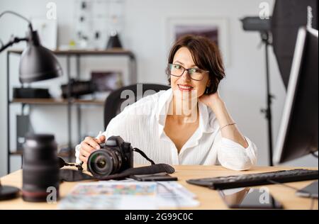 Female photographer at office Stock Photo