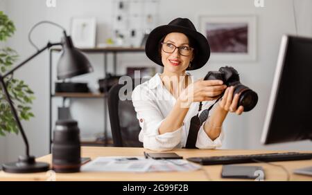 Female photographer at office Stock Photo