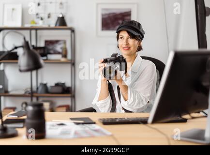 Photographer sitting at office Stock Photo
