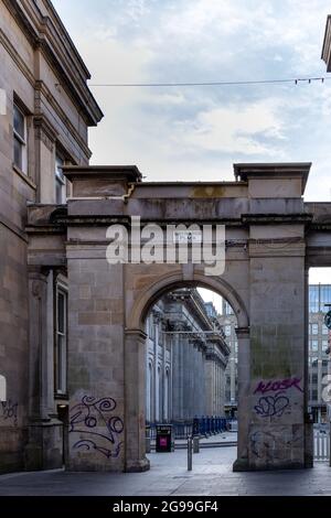 The arched entrance to Merchant City at Royal Exchange Square in Glasgow city centre, Scotland, Uk
