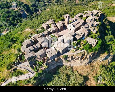 Civita di Bagnoregio, Italy. Famous medieval town connected with a long bridge to the mainland, aerial view from drone
