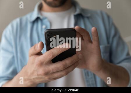 Close up view male hands holding modern cell phone Stock Photo