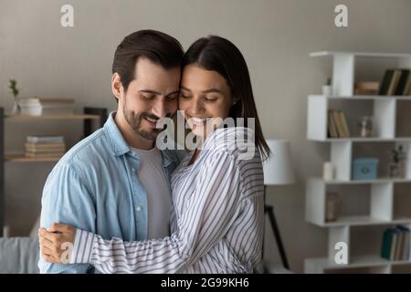 Couple in love cuddling standing inside of modern house Stock Photo