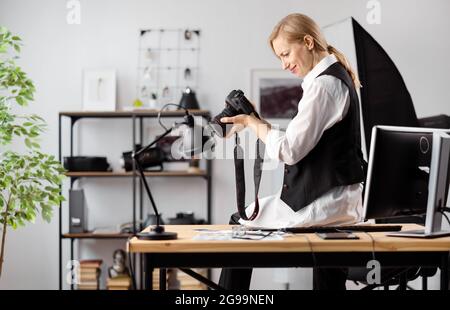 Photographer with camera at office Stock Photo