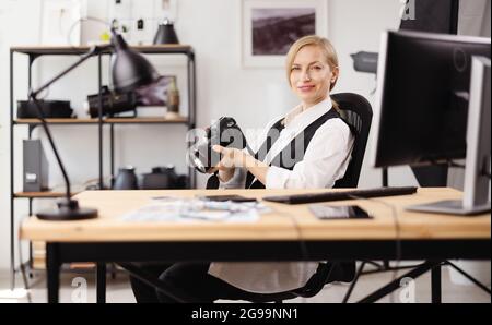Photographer sitting at office Stock Photo