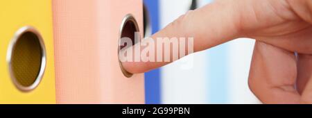 Woman's hand takes out folder with documents. Verification of reporting in the company concept Stock Photo