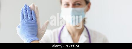 Two doctors in protective masks and gloves give each other five Stock Photo