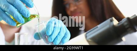 Two researchers are conducting experiments with chemical liquid in laboratory Stock Photo