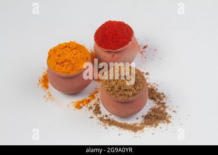 Indian Colourful Spices Also Know as Red Chilli Powder, Turmeric Powder, Coriander Powder, Mirchi, Mirch, Haldi, Dhaniya Powder Isolated on white Back Stock Photo