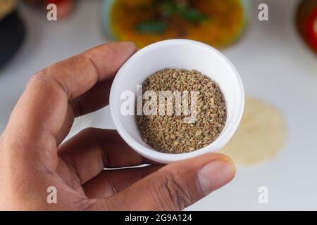a person holding a celery seed bowl in hand isolated on light background. Stock Photo