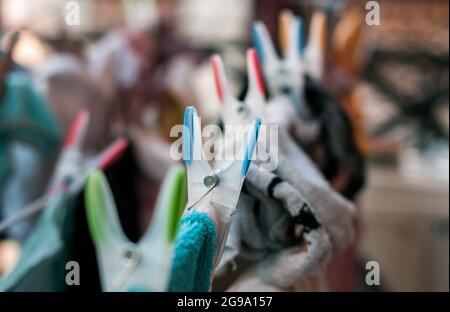 Laundry pins on ropes at home Stock Photo