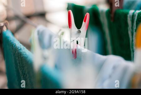 Laundry pins on ropes at home Stock Photo