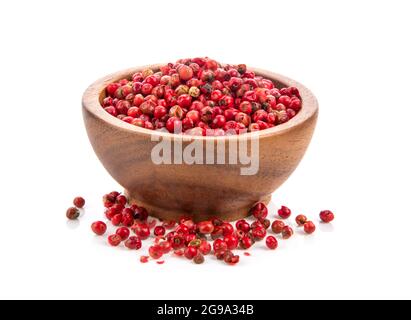 dried pink peppers in wood bowl isolated on white background Stock Photo