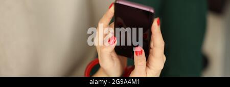 Female hands with lock hold smartphone closeup Stock Photo
