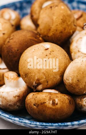 Raw Cremini Mushrooms in a bowl Stock Photo