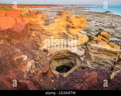 Sandstone rock hole created by erosion, Reddell Beach, Broome, Kimberley, Western Australia Stock Photo