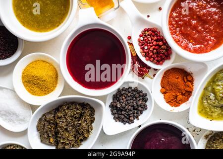 Bowls with georgian spices and sauces on white concrete background Stock Photo